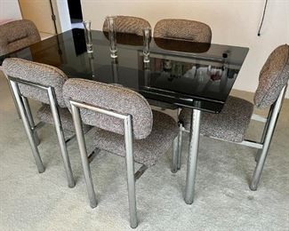 Post Modern tubular chrome and black glass dining table with 6 tubular matching chairs