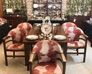 Square peg dining table with two leaves (8 feet long fully extended).
Set of six English bankers chairs upholstered and cowhide pattern Ultrasuede and stud trim.