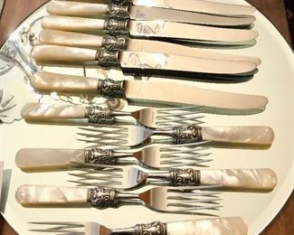 One of two sets of antique MOTHER OF PEARL with sterling cuff cutlery set,  8 forks and knives. Matching carving set also available.
