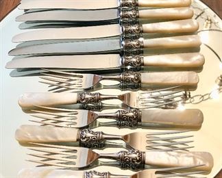 One of two sets of antique mother of pearl with sterling cuff cutlery set,  8 forks and knives  