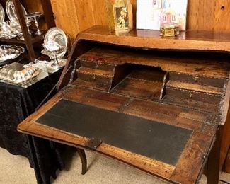 Mid to late 1800s marquetry desk. Secret drawer. Exhibit signs of use and age. Multiple ink stains inside from over a century and a half of use.