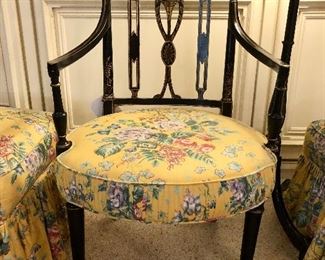 Napoleon III black lacquer chair. Frame is decorated and guilt urn and drape motif. Elegant shaped open arms with gilded supports.