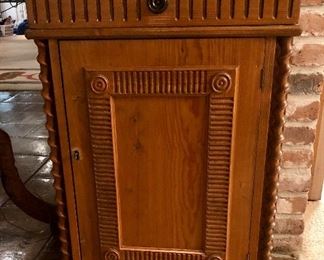 Quarter sawn cabinet. Deep relief center panel, barley twist columns, bracket feet. Locking doors. One of two matching pieces.