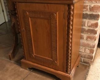 Quarter sawn cabinet. Deep relief center panel, barley twist columns, bracket feet. Locking doors. One of two matching pieces.