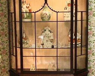 Antique mahogany lighted display cabinet. Glass front with two locking glass panel side doors. Marvelous Mahogany fretwork. A statement in any room. Two locking keys kept at the register.