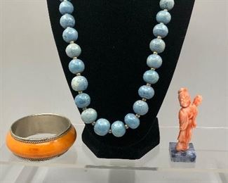 Natural stone necklace, Inuit carved bone polar bear, carved coral figurine. 