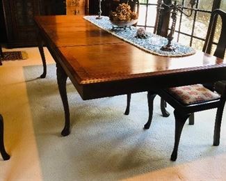 Mahogany dining table with contrasting border and narrow herringbone inlay - with cabriole legs(slightly carved knee) with pad foot /4 leaves(each one foot) / with leaves the table measure 9 feet x 42 inches wide/ without leaves 5 feet x42 wide.