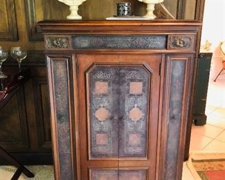 This beautiful Victrola is a V V 8-1, also referred to as The Credenza.  This piece was purchased by and resided in the home of Mrs. Friedman’s parents, the late Barney and Fannie Kahn of Pelham, Ga. 
The Credenza (also referred to as the VV 8-1, and later as the VV 8-30) was the first of four premiere Orthophonic models that were introduced in the late fall of 1925, and represented the pinnacle of audio reproduction in the mid-1920's. These revolutionary machines provided far better sound-quality than any of the earlier Victrola models, with superior frequency response, higher volume, and a far less "canned" sound quality than was experienced with the previous generation of acoustic phonographs. For an extra 50.00 you could purchase a model with more designs such as this one.   It originally retailed for 275.00.