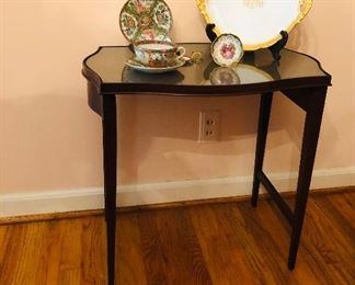 Pretty small side table serpentine edge with serpentine carved inlay  Leather top