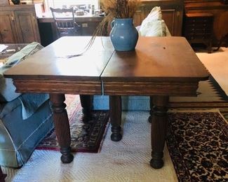 Oak table 1900-1920 with 5 heavily grooved round legs. Measures 40 in without leaves.