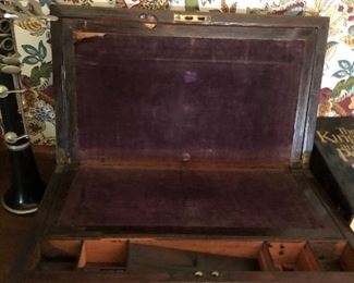 Inside of Lap desk late 19th century rosewood case with hinged top and having velvet stretched hinged writing surface with 2 open wells and one lidded well.