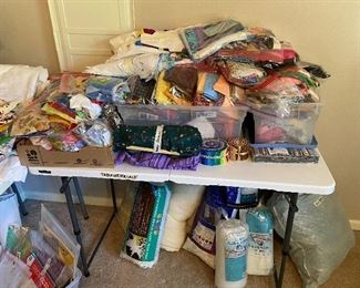 Batting, fabric carrier, large bag, ribbon, fabric quilting strips, cut fabric quilting squares, various completed quilting pieces and more!