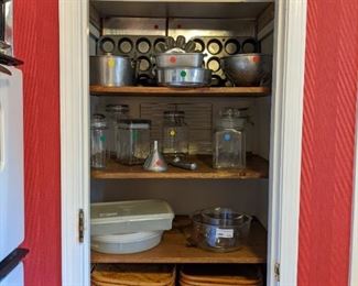 Vintage Tupperware items, aluminum bakeware, glass storage containers and bamboo picnic trays. 