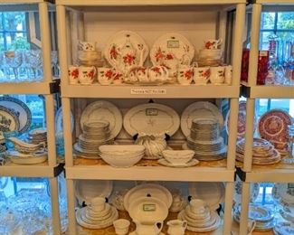 Collection of red glass items, 74-piece set of Royal Albert "Poinsettia" bone china, 54-piece set of Noritake "Chaumont" china, 46-piece set of Adam's English ironstone "Empress" china and assorted silverplated items. 