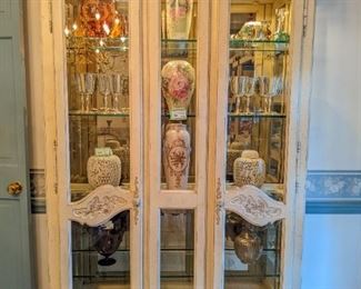 Vintage antiqued wood lighted curio cabinet, by White Furniture Co., Mebane, NC, filled w/silverplated goodies, Asian porcelains and hand-painted porcelain vases. 