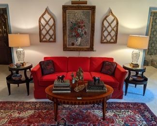 Living room with comfy red couch, pair of 1930's mahogany 2-tiered tables, with tooled leather tops and glass to protect it all, nicely banded mahogany coffee table, pair of Bohemian cut glass table lamps, w/shades, finials and marble bases, pair of cathedral wooden windows and nicely framed original oil on canvas, w/gallery light, by A. Rabin.
