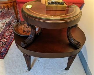 Close-up shot of the pair of 1930's mahogany 2-tiered tables, with tooled leather tops and glass to protect it all.