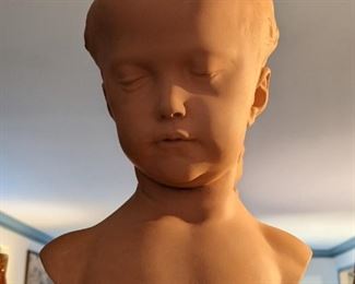 Sweet terra cotta bust of innocent girl.