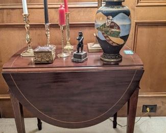 Vintage drop-leaf mahogany, single drawer, Pembroke Table, w/string inlay, brass candlestick collection, Japanese Porcelain Vase and 1950's bear trophy.