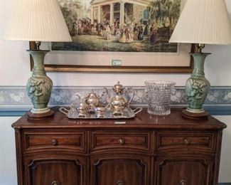 Vintage pecan Henredon 3 door/drawer buffet, with silverplated tea/coffee service, cut glass ice bucket, pair of vintage Asian porcelain celadon green porcelain lamps, w/shades, finials and nicely framed/matted "Gone With the Wind"-ish scene.