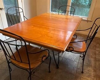 Like new, real wood and wrought iron dining room table with a removable leaf, great for a breakfast nook or three seasons room 