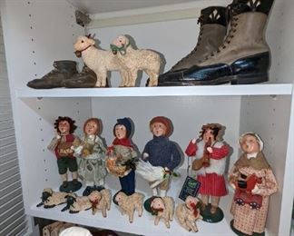 A collection of European carolers and handmade sheep. Also a collection of antique shoes and baby shoes.