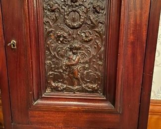 Antique Wood Cabinet with Carved Cherub Scene