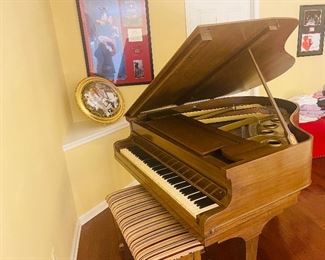 Baby grand piano with bench