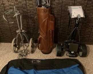 2 golf pull carts 2 golf travel bags 2 golf bags with various clubs