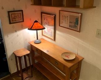 Nice lamp on nice table next to a nice stand