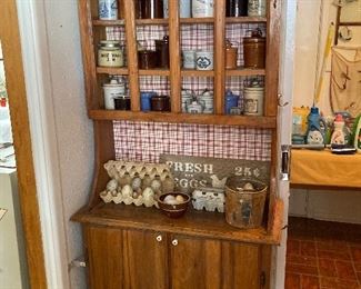 small wood hutch, crocks, eggs