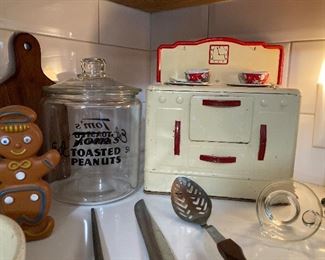 Tom's Toasted Peanuts jar, Wolverine child's stove, Ohio Art tin litho child's dishes and utensils, Cutco slotted spoon