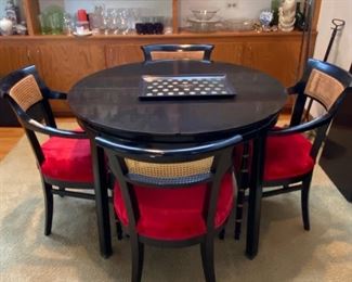 Gorgeous Mid-Century Modern Dining Table with 4 Chairs. This table has 3 Leaves with 4 Red Velvet Seat Cane Back Armed Chairs. Very Cool Retro Look