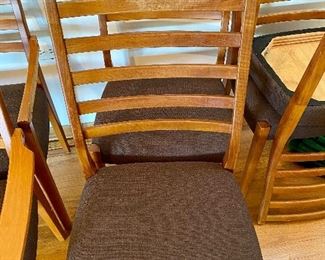 Mid-Century Modern set of 6 Teak Ladder Back Chairs.  The chairs were re-upholstered about 2 years ago.  Set consists of 2 Armed Chairs and 4 Dining Chairs.  One of the Armed Chairs needs the arm repaired.