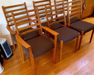 Mid-Century Modern set of 6 Teak Ladder Back Chairs.  The chairs were re-upholstered about 2 years ago.  Set consists of 2 Armed Chairs and 4 Dining Chairs.  One of the Armed Chairs needs the arm repaired.