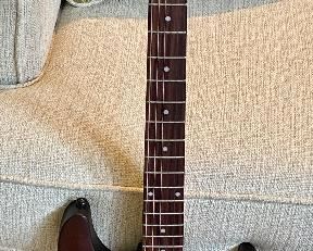 Beautiful Schecter Diamond Series Electric Guitar. Color: Walnut with Maple, Rose Wood and Basswood
Neck is Maple with a Solid body Electric Guitar,
2 Humbucking Pickups,  Rosewood Fingerboard.  Includes a custom case made for this guitar.