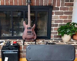 Beautiful Schecter Diamond Series Electric Guitar. Color: Walnut with Maple, Rose Wood and Basswood
Neck is Maple with a Solid body Electric Guitar,
2 Humbucking Pickups,  Rosewood Fingerboard.  Includes a custom case made for this guitar.