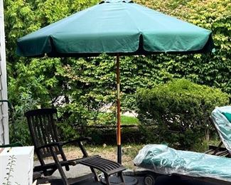 Teak lounge chairs with ottomans and umbrella