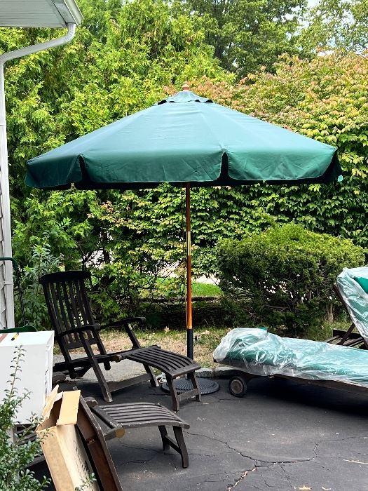 Teak lounge chairs with ottomans and umbrella