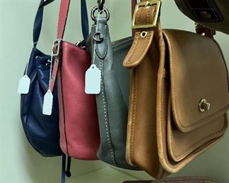 A LARGE ASSORTMENT OF COACH BAGS AND WALLETS