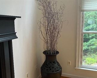 Large black decorative urn with long decorative twigs
