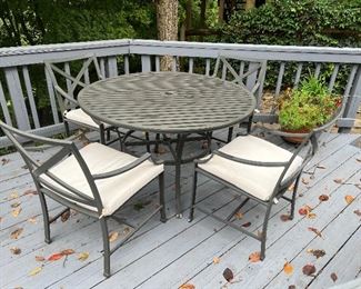 Outdoor aluminum round dining table and 4 aluminum outdoor armchairs with pads