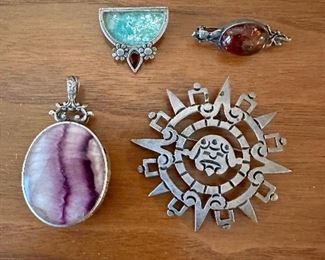 Sterling silver brooches, pendants, and pins
