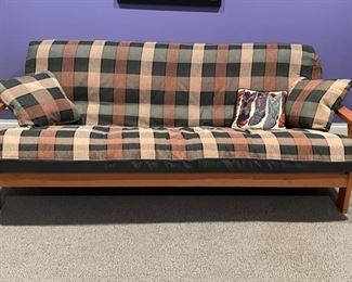 Futon with plaid cushion. Measures 80" W. 