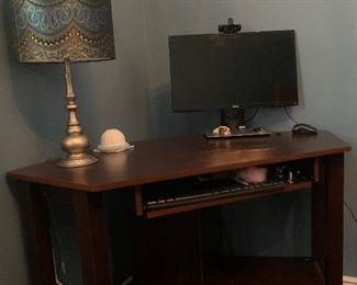 Corner desk, lamp, computer monitor with charging station