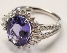 15z - Platinum Tanzanite & Diamond Ring Size 6 Tanzanite set within a diamond bezel, supported by a ribbed under gallery & diamond set split shoulders, completed by a two millimeter wide band. Total weight of colored stones 4.49ct Total weight of diamonds 1.32ct