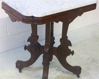 21 - Victorian Walnut Heavily Carved Parlor Table w/ Marble Top and Cookie Cut Corners 30 x 27 x 20 - w/ wheels