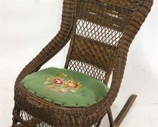 669 - Vintage original finish wicker rocker needlepoint seat some holes in back 39 x 23 x 26