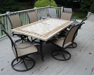 Agio stone top table with 6 swivel rockers