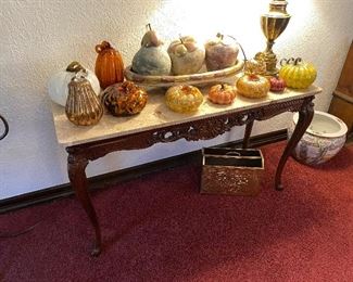 Lots of glass pumpkins! Marble top carved wood sofa table